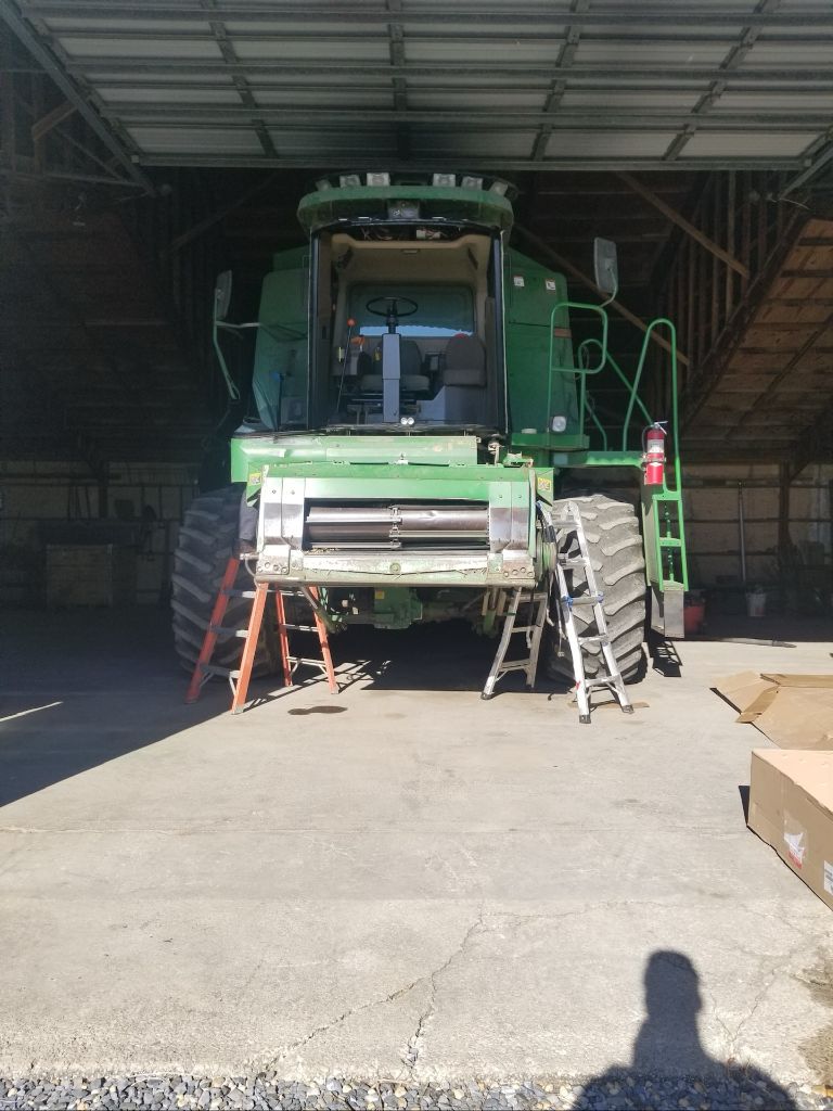Combine harvester cab glass replacement on farm