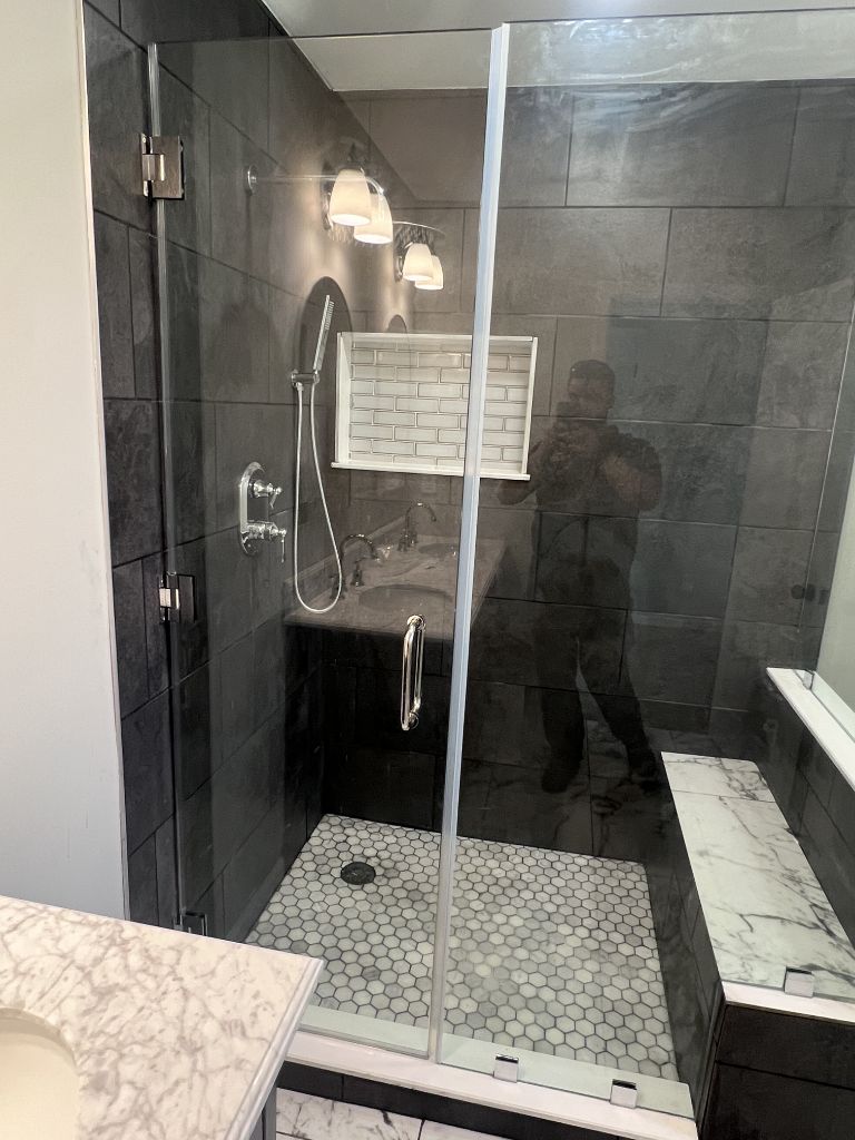 Frameless shower dark tile
