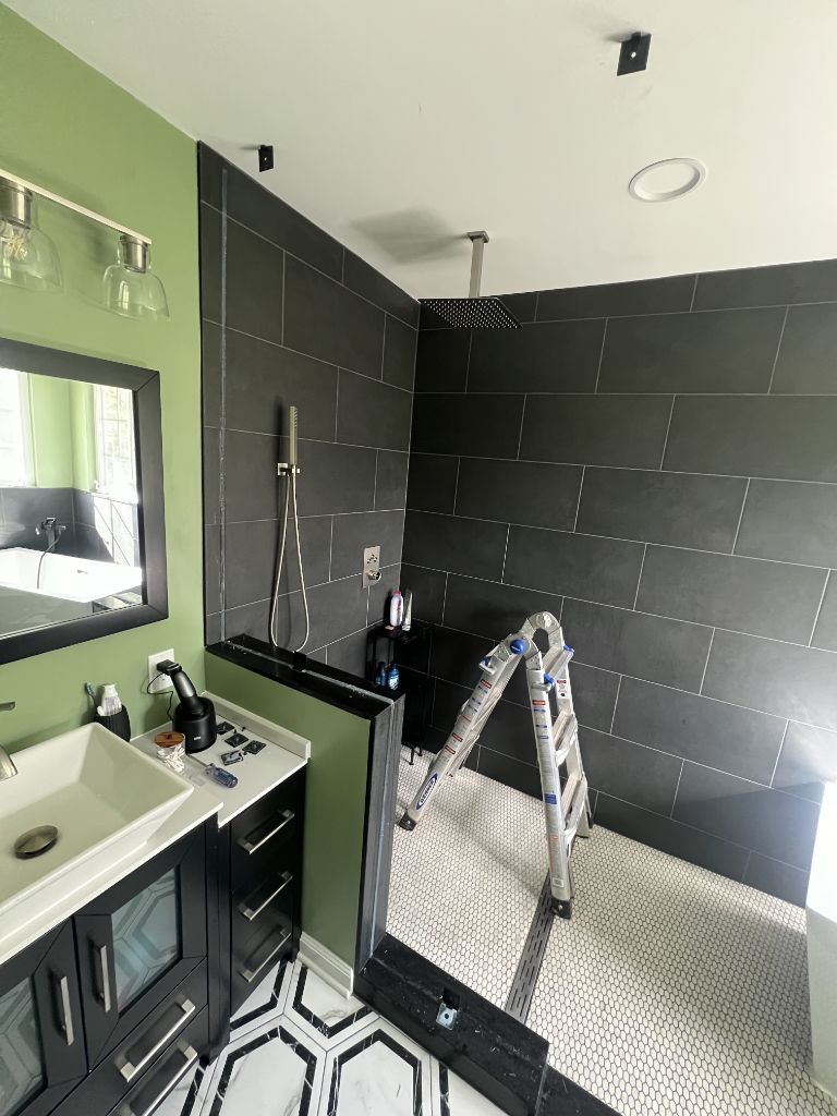 Open concept walk-in shower with frameless glass panel